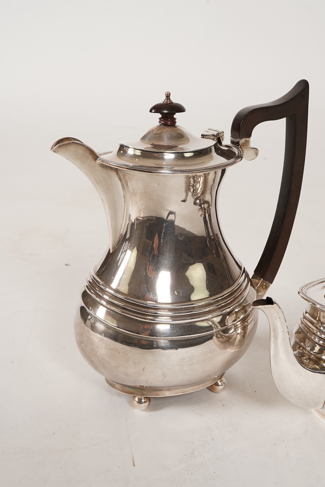 A George V four piece silver tea set, comprising teapot, hot water pot, sugar bowl and milk jug, by S. Blanckensee & Son Ltd